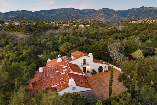 bird's eye view with a mountain view and a view of trees