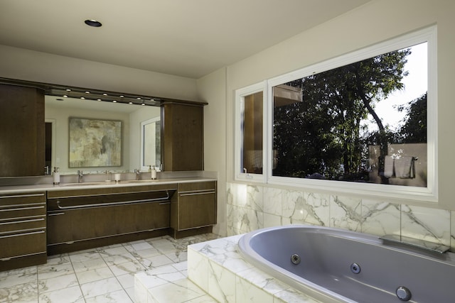 full bath with double vanity, marble finish floor, a sink, and a whirlpool tub