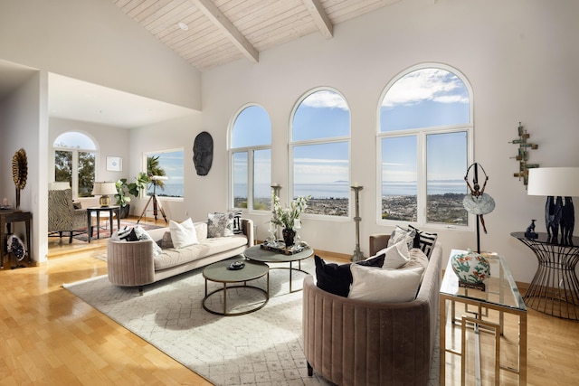 living room with high vaulted ceiling, wooden ceiling, beamed ceiling, and light wood-style flooring