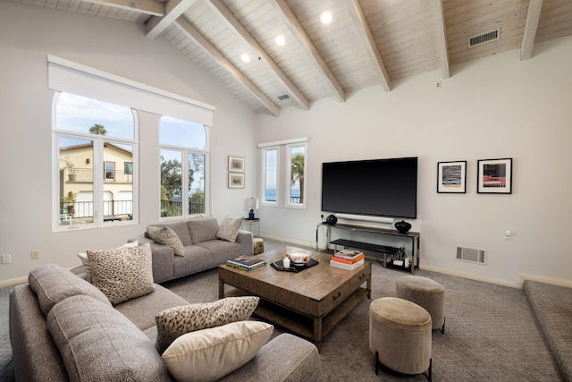 living room with baseboards, visible vents, beamed ceiling, and carpet flooring