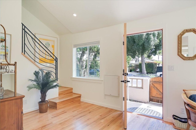 doorway with baseboards, light wood-style flooring, stairway, vaulted ceiling, and recessed lighting