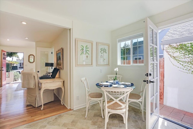 dining room with light wood finished floors, plenty of natural light, and recessed lighting