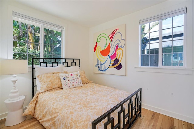 bedroom with wood finished floors and baseboards