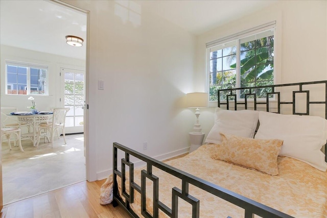 bedroom with baseboards and wood finished floors