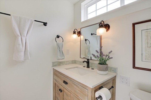 bathroom with toilet and vanity