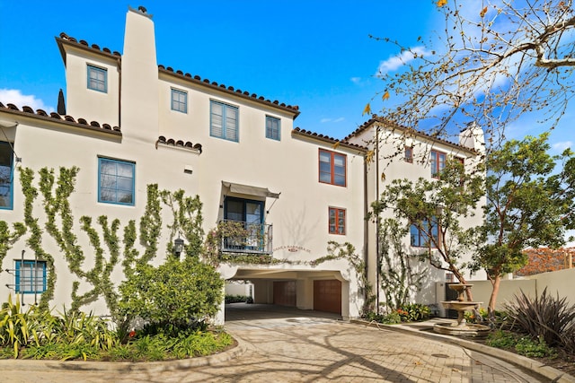 view of property featuring driveway and a carport