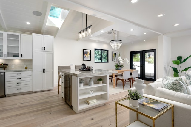 living area featuring recessed lighting, light wood-type flooring, beam ceiling, and french doors