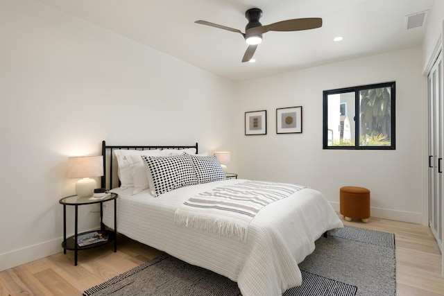 bedroom featuring light wood-type flooring, visible vents, baseboards, and recessed lighting