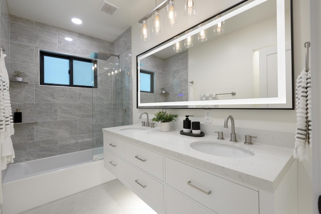 bathroom featuring a sink, visible vents, shower / washtub combination, and double vanity