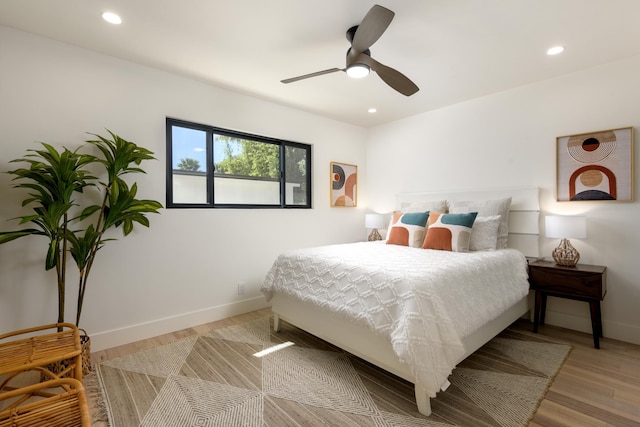 bedroom featuring recessed lighting, wood finished floors, and baseboards