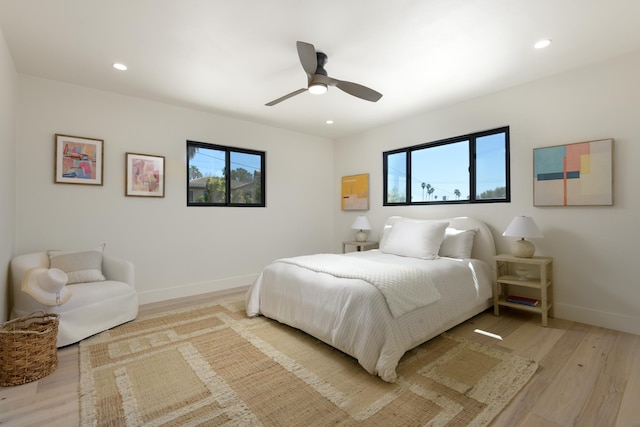 bedroom featuring recessed lighting, baseboards, light wood-style flooring, and ceiling fan