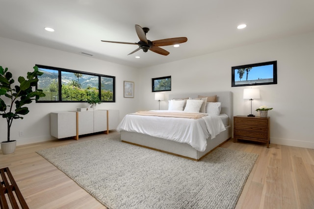 bedroom with light wood finished floors, visible vents, baseboards, recessed lighting, and a ceiling fan