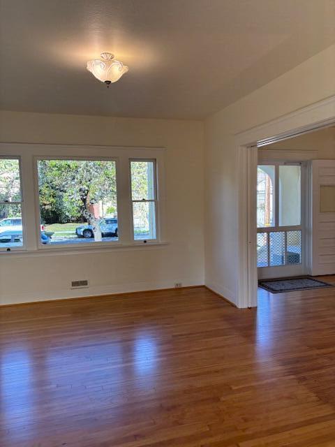 spare room featuring wood finished floors