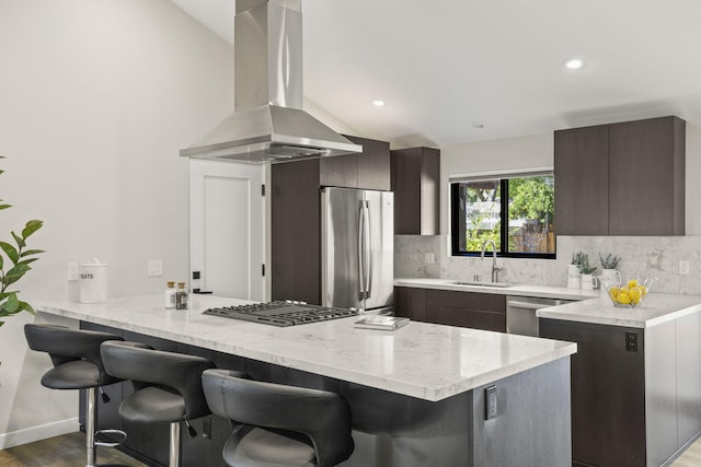 kitchen featuring appliances with stainless steel finishes, modern cabinets, a sink, and island range hood