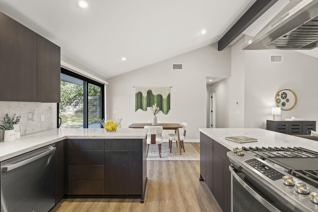 kitchen featuring vaulted ceiling with beams, modern cabinets, and stainless steel appliances