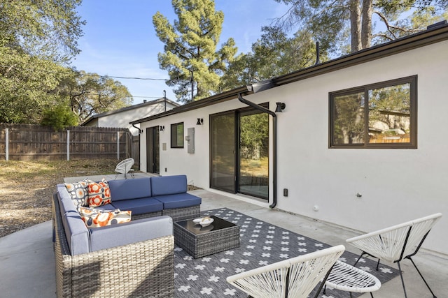 view of patio featuring an outdoor hangout area and fence