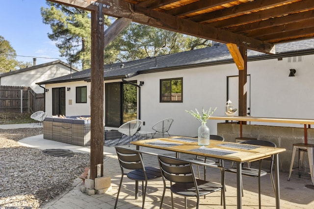 view of patio featuring outdoor dining area and fence