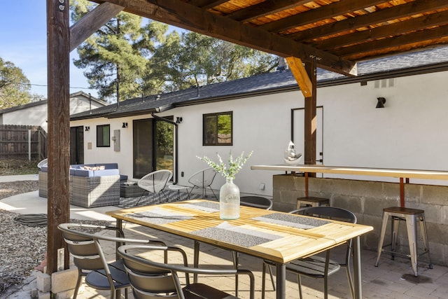 view of patio / terrace with outdoor dining area and fence