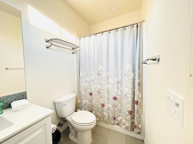 bathroom featuring tile patterned flooring, shower / tub combo, toilet, and vanity