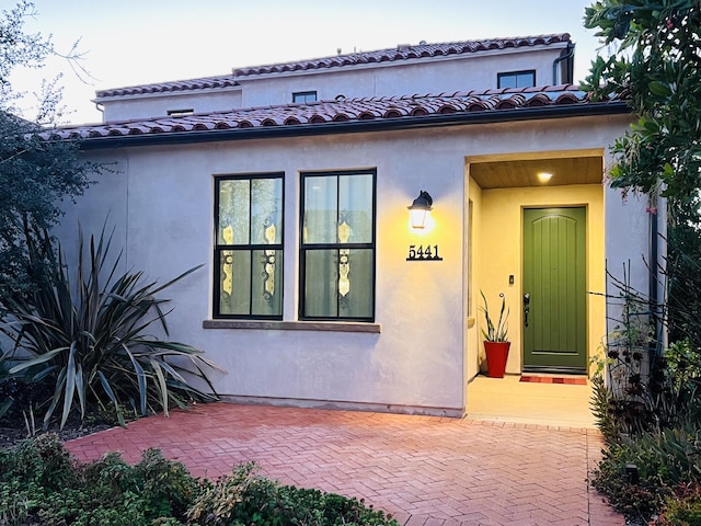 view of front of property with stucco siding and a tiled roof