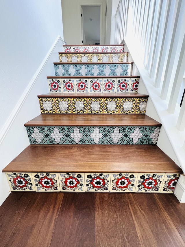 stairway featuring wood finished floors