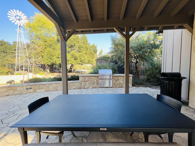 view of patio featuring outdoor dining space, area for grilling, and fence