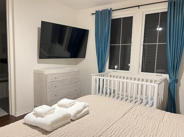 bedroom featuring baseboards and wood finished floors