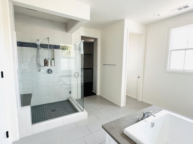 full bath with a tub to relax in, baseboards, visible vents, a stall shower, and tile patterned floors