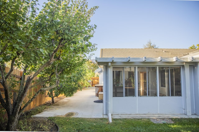 back of property with a patio area and fence