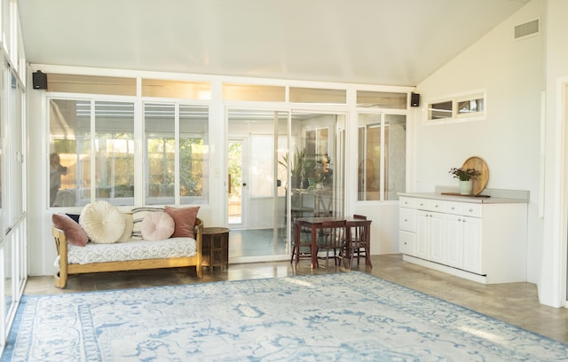 sunroom / solarium with visible vents and vaulted ceiling