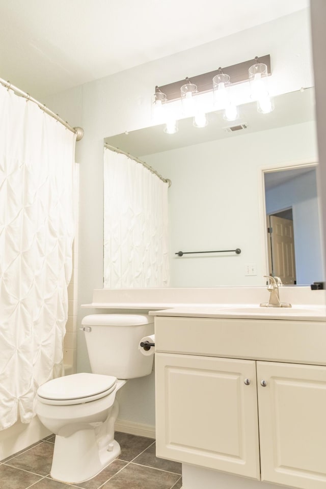 bathroom featuring visible vents, toilet, vanity, a shower with curtain, and tile patterned floors