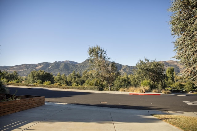 view of street featuring a mountain view and sidewalks