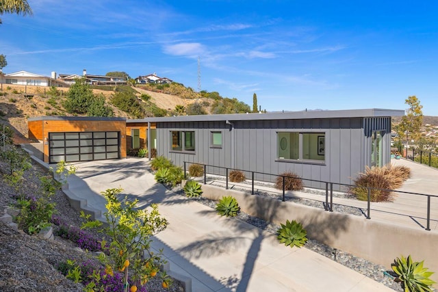 153 Nob Hill Ln, Ventura, CA 93003 - view of front of home featuring board and batten siding, driveway, a garage, and a fenced front yard