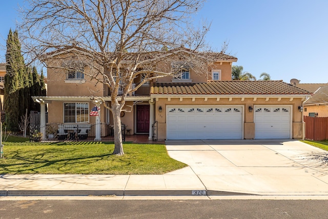 mediterranean / spanish home featuring concrete driveway, an attached garage, fence, a front lawn, and stucco siding