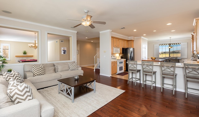 living area featuring dark wood-style floors, recessed lighting, ornamental molding, and a ceiling fan