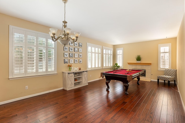 game room featuring a notable chandelier, dark wood-type flooring, a premium fireplace, billiards, and baseboards