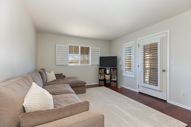 living room featuring dark wood-style floors and baseboards