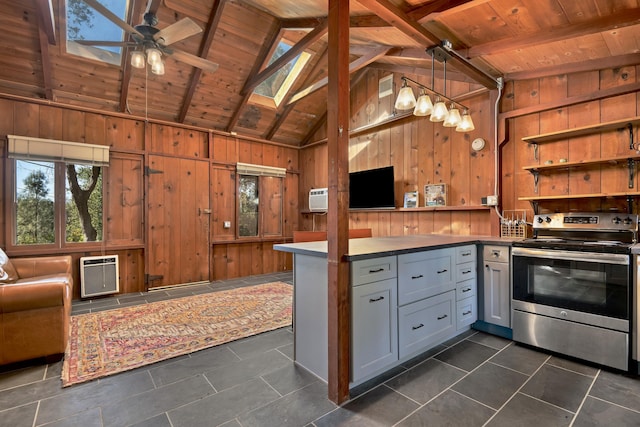 kitchen with open floor plan, wooden walls, stainless steel electric range, and heating unit