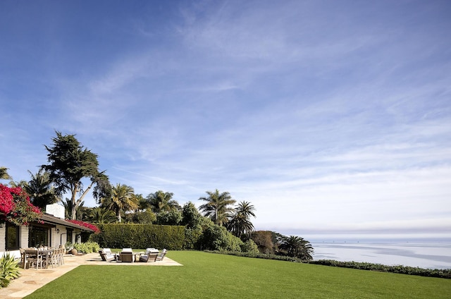 view of yard featuring a water view and a patio