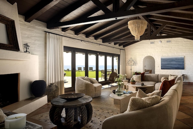 living room featuring vaulted ceiling with beams, wooden ceiling, arched walkways, and a fireplace with raised hearth