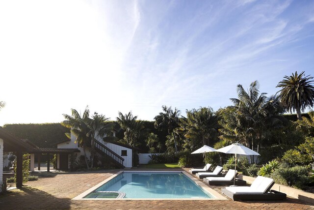 outdoor pool with a patio area and stairway