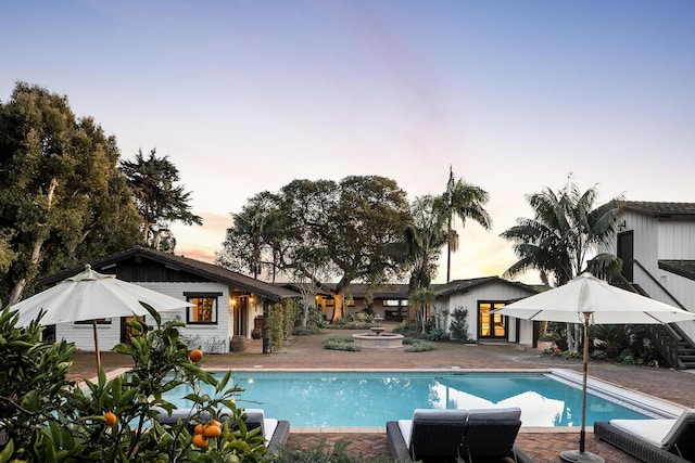 pool featuring french doors and a patio area