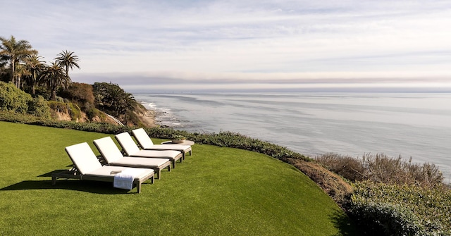 view of property's community featuring a water view and a yard