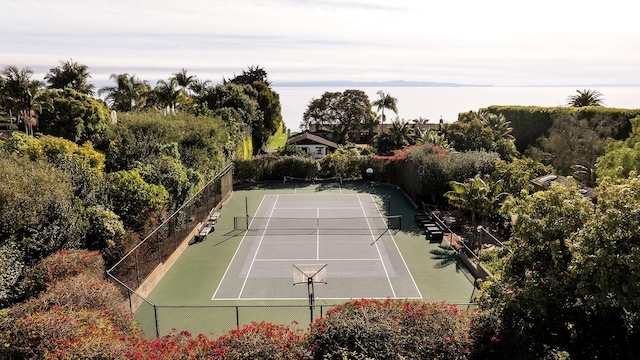 view of tennis court with fence