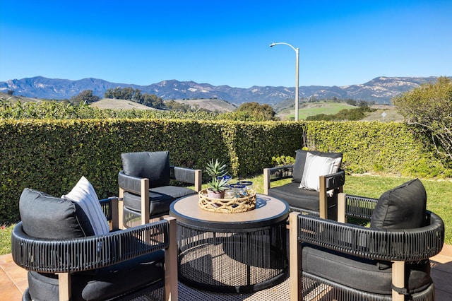 view of patio with a fenced backyard, a mountain view, and outdoor lounge area