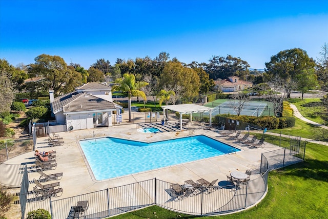 community pool with a patio area, fence, and a pergola