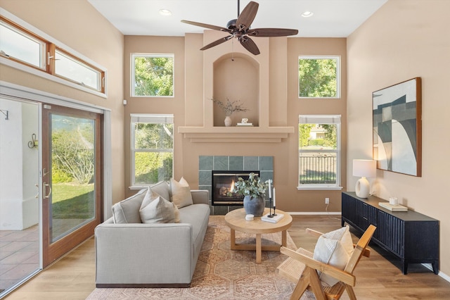 interior space featuring plenty of natural light, a tiled fireplace, and wood finished floors