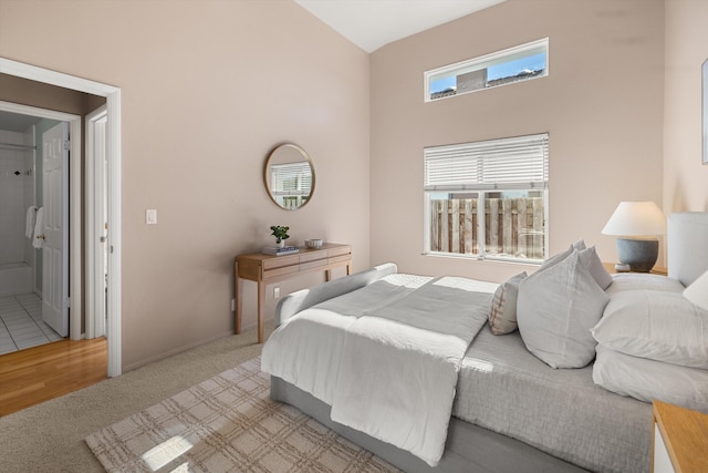 carpeted bedroom with a high ceiling