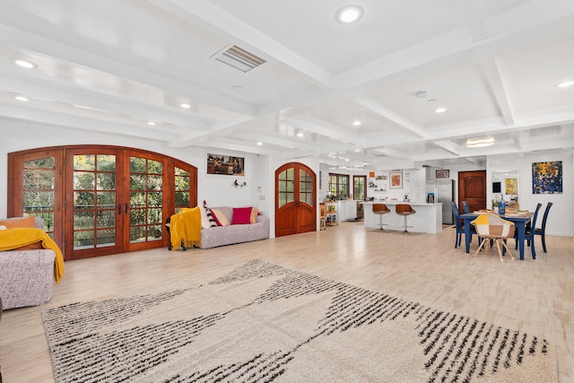 living area with french doors, beam ceiling, recessed lighting, visible vents, and light wood-style flooring