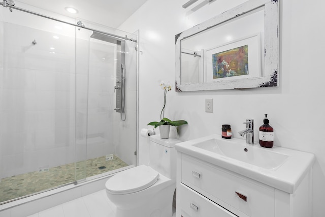 bathroom featuring toilet, a shower stall, and vanity